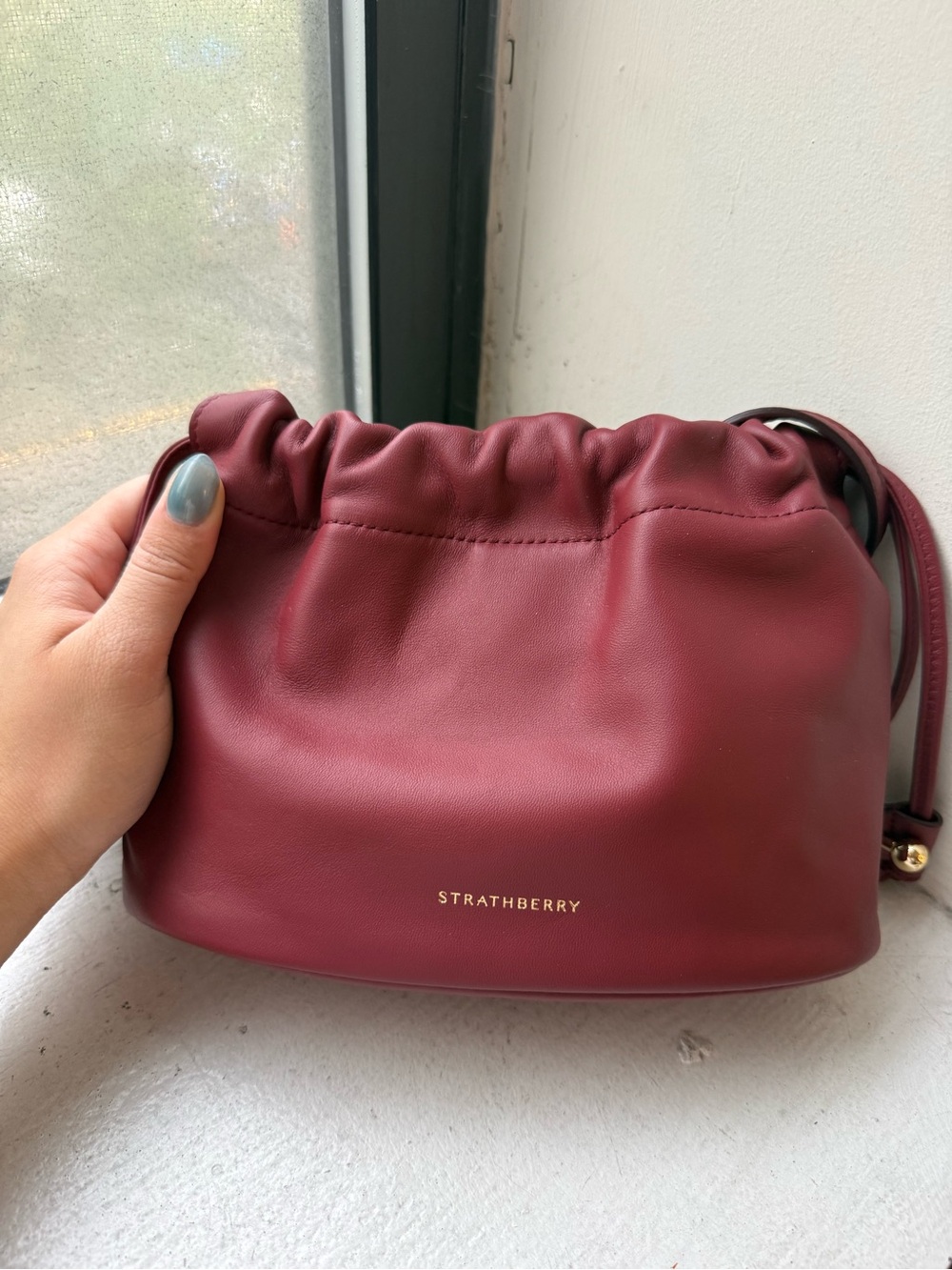 Strathberry charlotte drawstring clutch (oxblood)